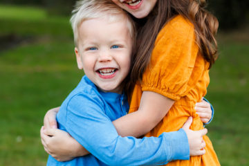 two kids hugging giving genuine smiles